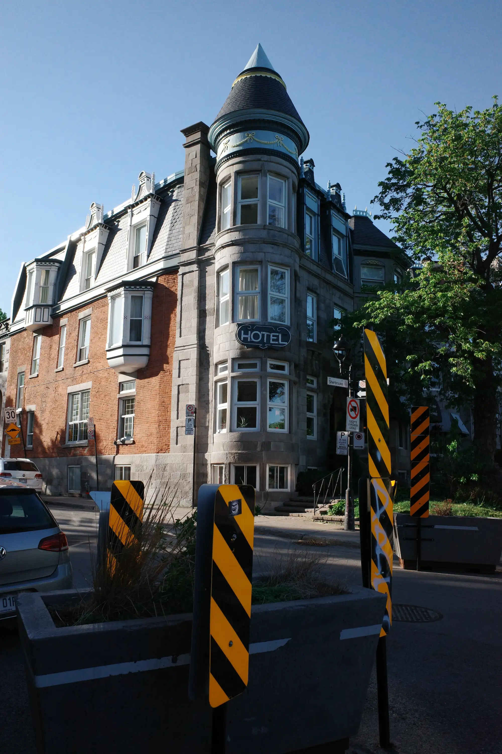 A turreted stone hotel on a Montreal corner